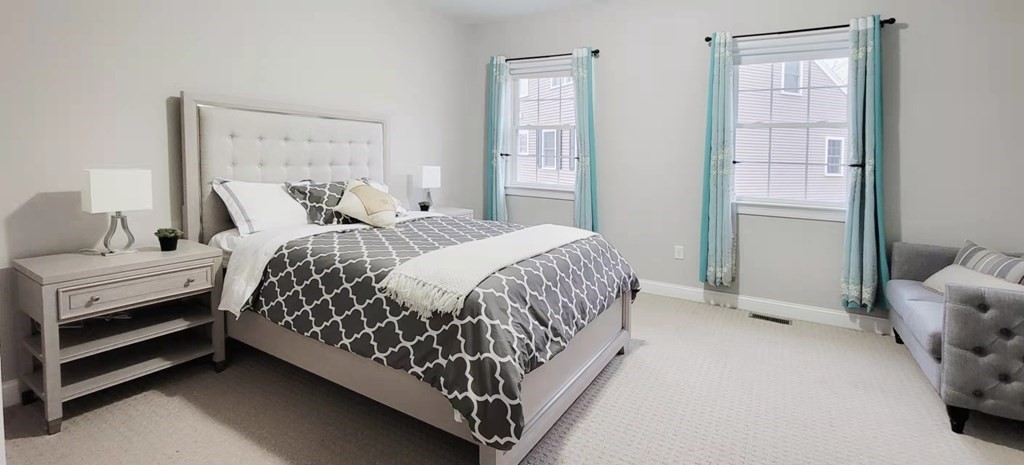 797 Highland Avenue, Unit 4 Needham, MA 02494 - Photo 9 of 21 a bed sitting in a bedroom next to a window