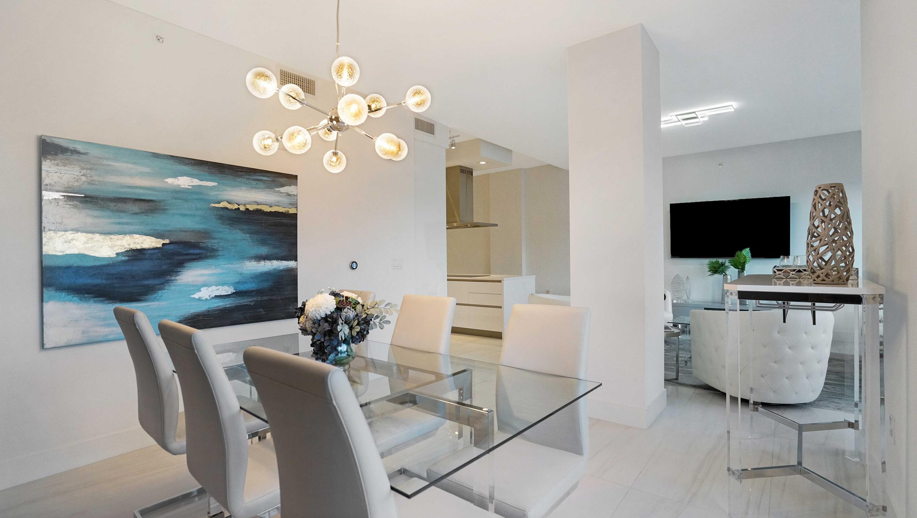 155 East Boca Raton Road, Unit 501 Boca Raton, FL 33432 - Photo 12 of 83 a living room with furniture a flat screen tv and kitchen view