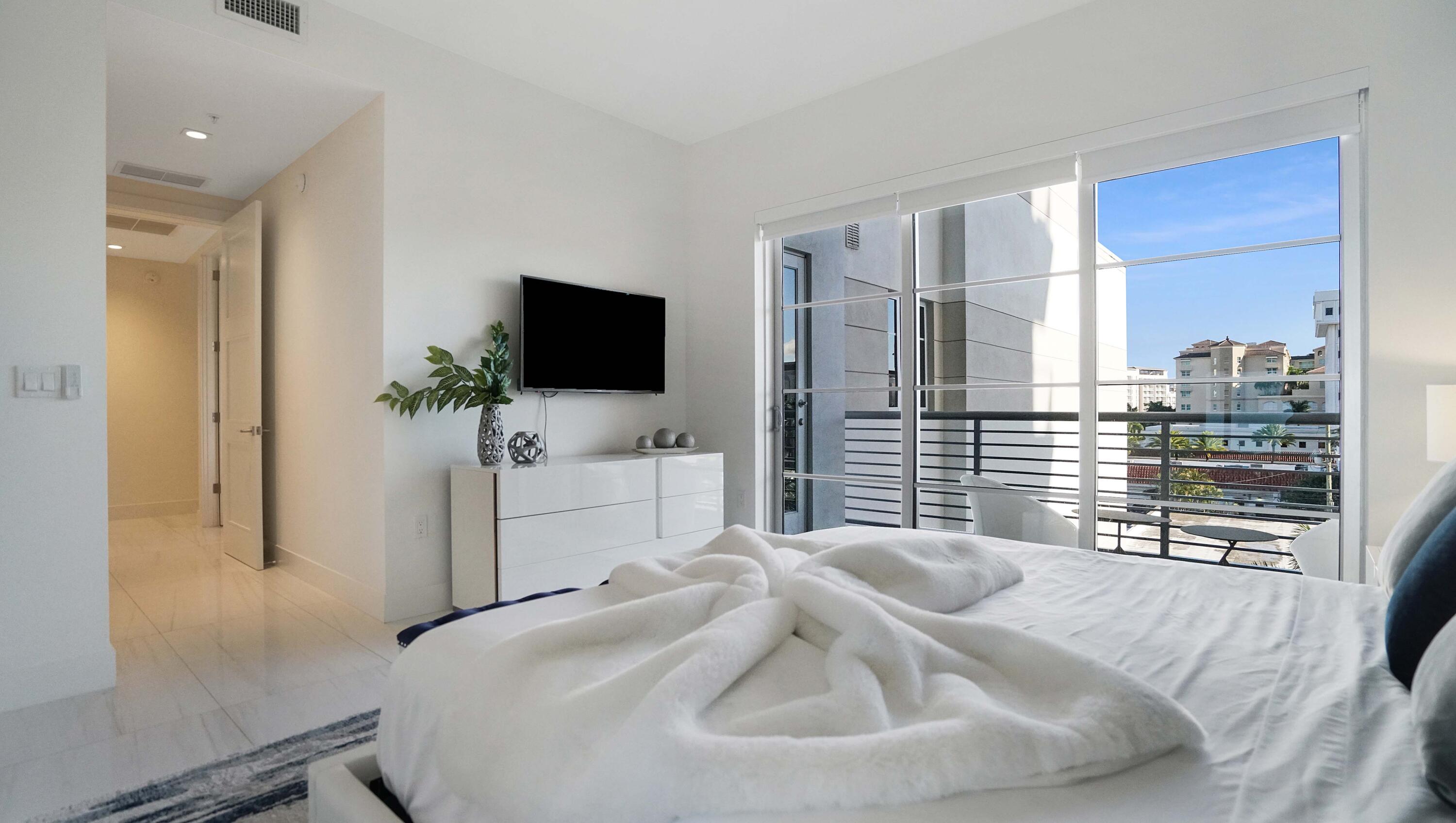 155 East Boca Raton Road, Unit 501 Boca Raton, FL 33432 - Photo 22 of 83 a bedroom with a bed and a flat screen tv