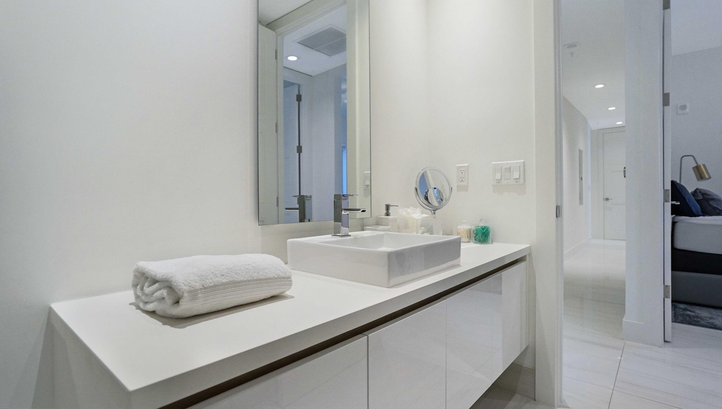 155 East Boca Raton Road, Unit 501 Boca Raton, FL 33432 - Photo 28 of 83 a en suite bathroom with a sink and a mirror