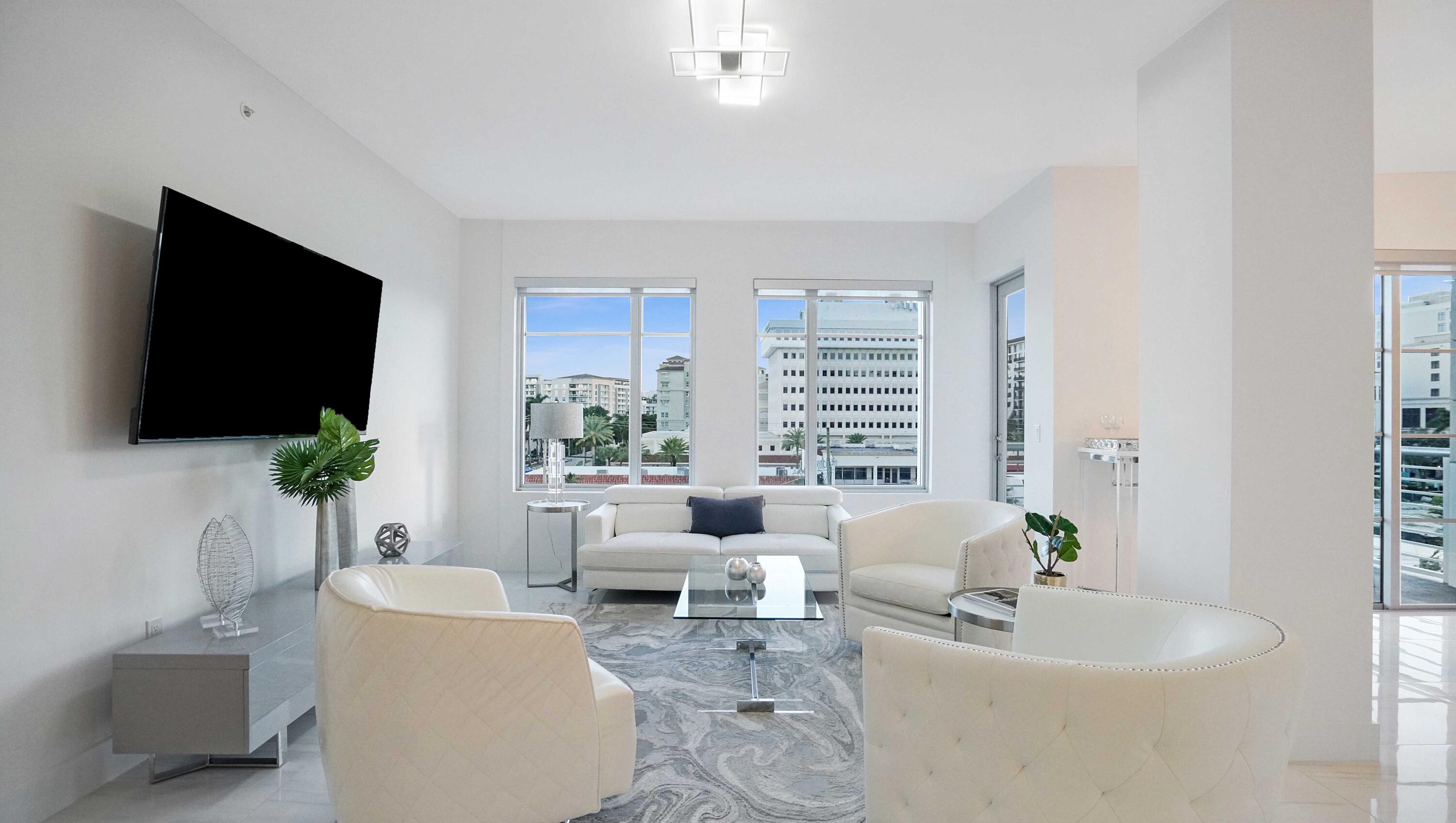 155 East Boca Raton Road, Unit 501 Boca Raton, FL 33432 - Photo 46 of 83 a living room with furniture a flat screen tv and a large window