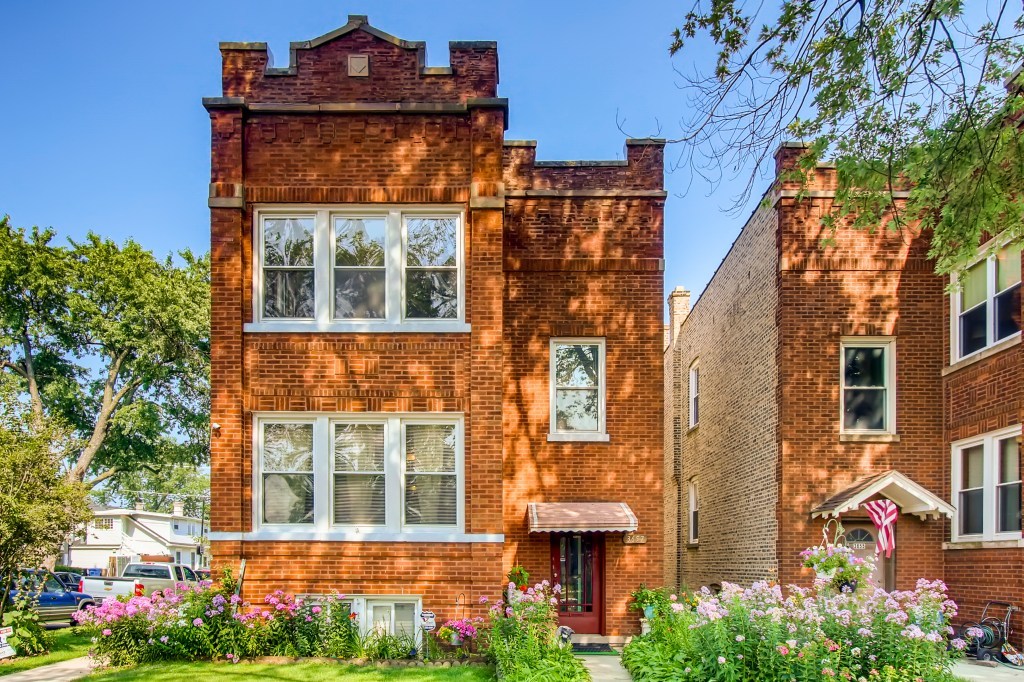 3657 North Lotus Avenue Chicago, IL 60641 - Photo 1 of 29 front view of a brick house with a yard