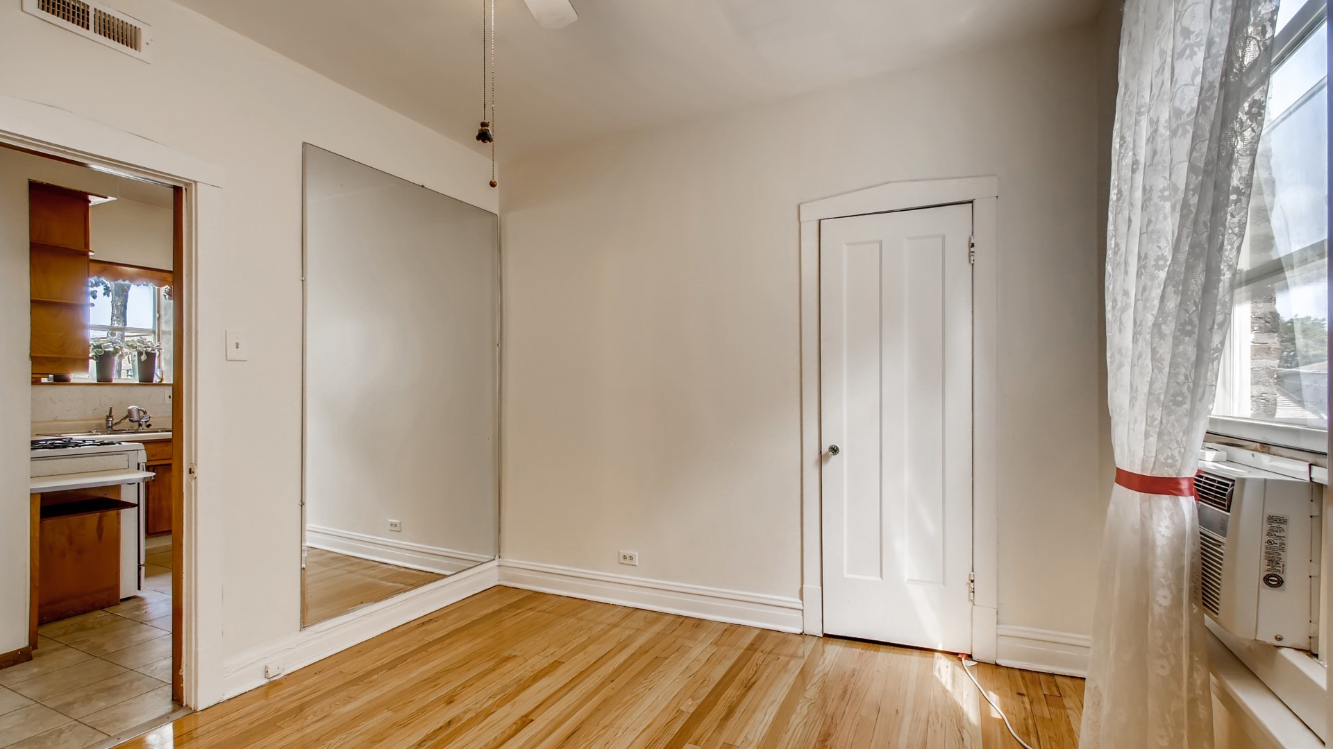 3657 North Lotus Avenue Chicago, IL 60641 - Photo 15 of 29 a view of empty room with wooden floor and fan