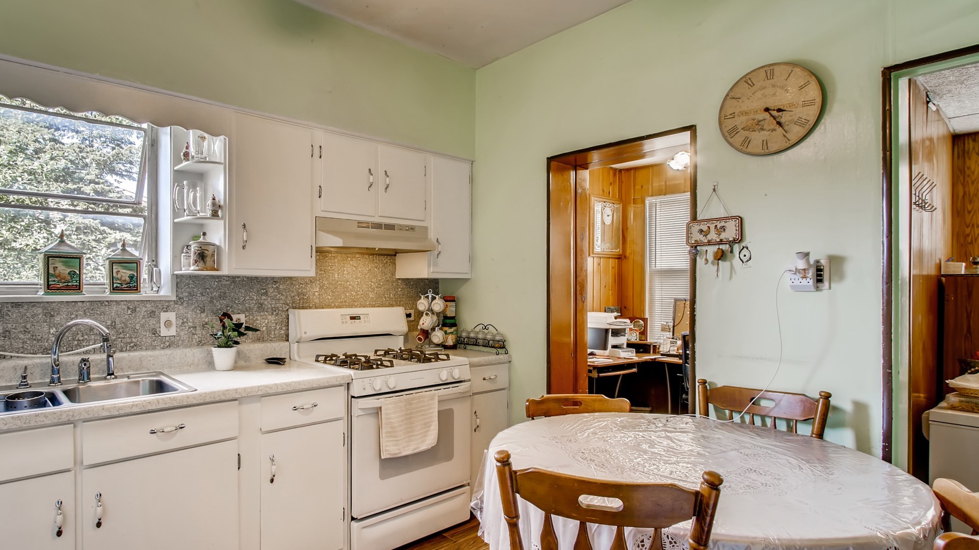 3657 North Lotus Avenue Chicago, IL 60641 - Photo 7 of 29 a kitchen with a table chairs and white cabinets