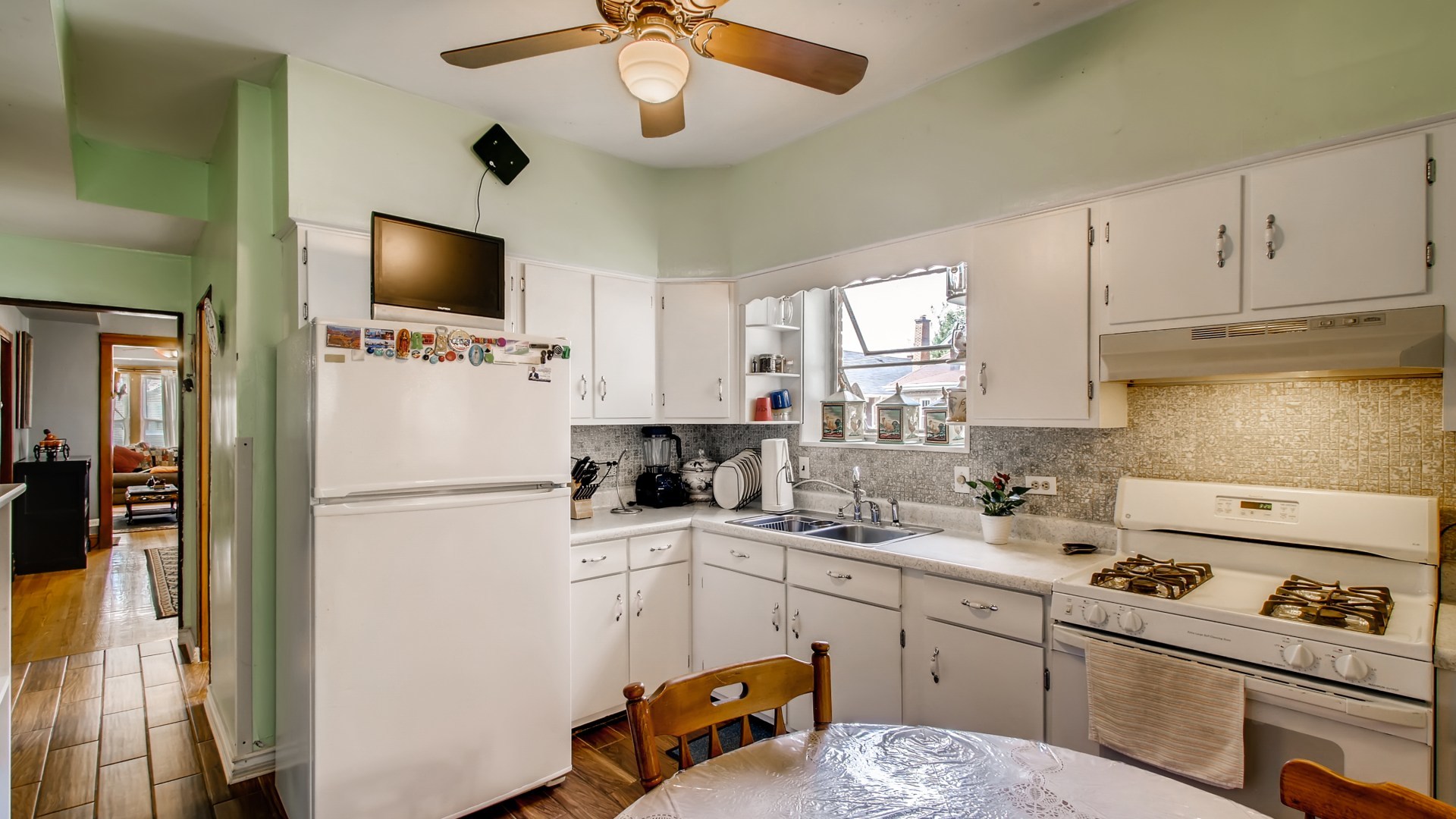 3657 North Lotus Avenue Chicago, IL 60641 - Photo 9 of 29 a kitchen with a sink stainless steel appliances and white cabinets