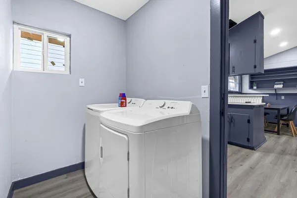 a utility room with cabinets washer and dryer