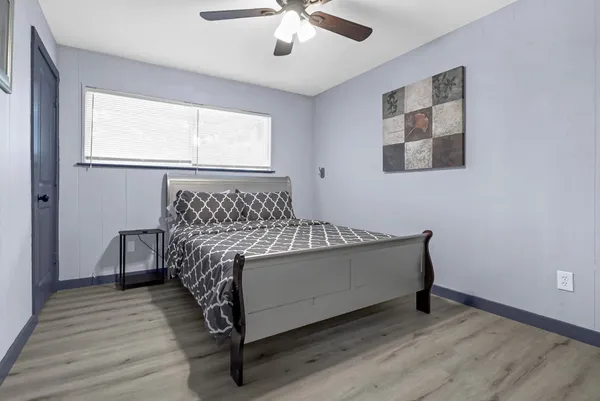 a bed sitting in a bedroom next to a window