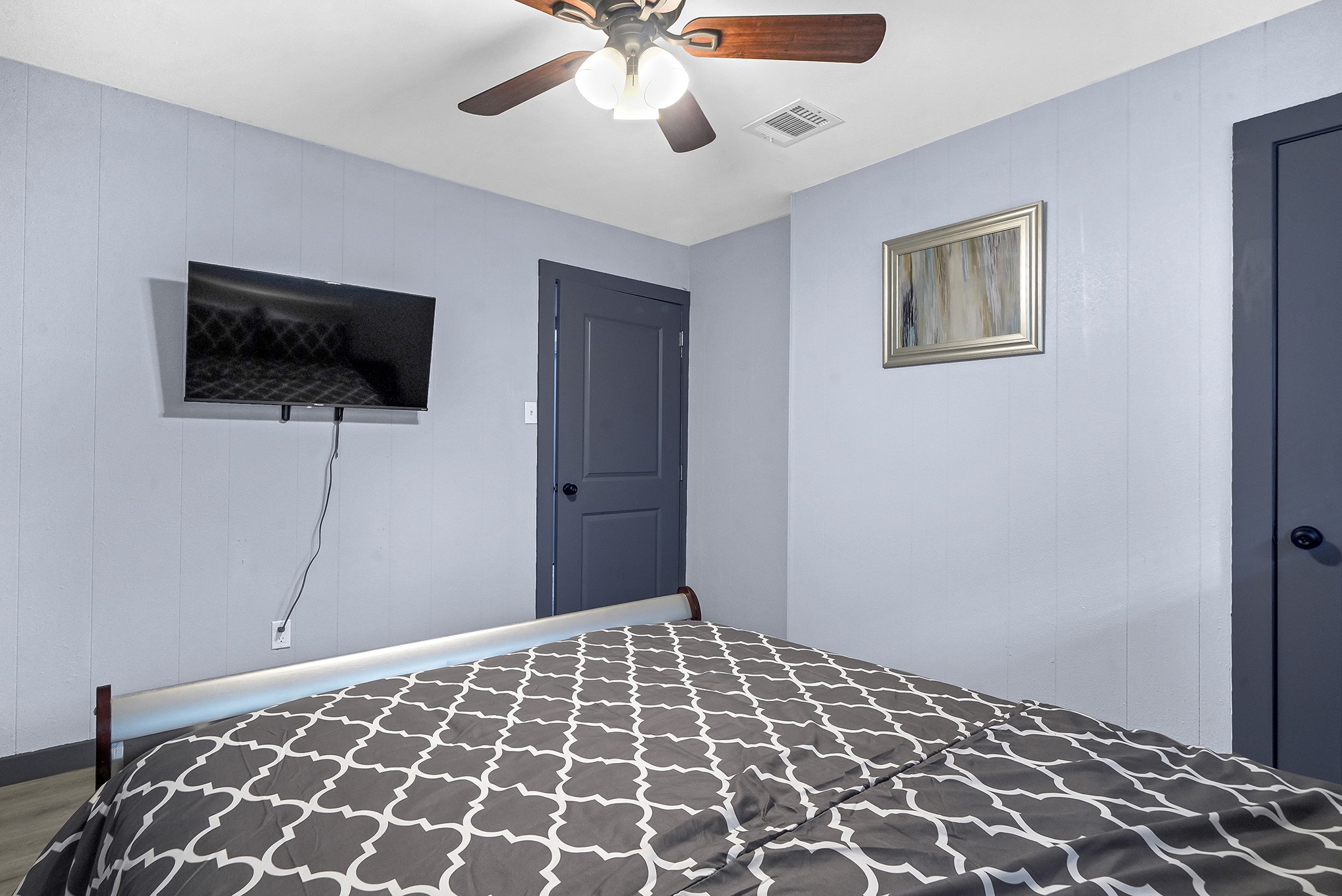 11103 Greenwillow Street Houston, TX 77035 - Photo 13 of 27 a bedroom with a bed and a flat screen tv