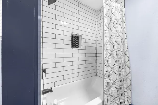 a bathroom with a bathtub and shower