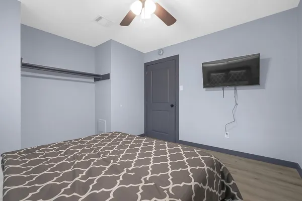 a bedroom with a bed and a flat screen tv