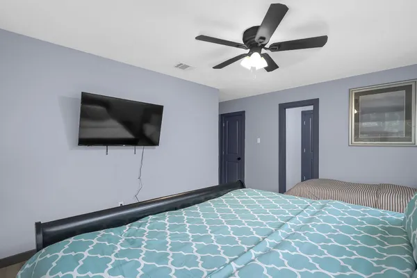 a bedroom with a bed and a flat screen tv