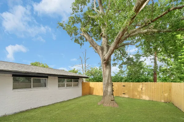 a view of house with backyard
