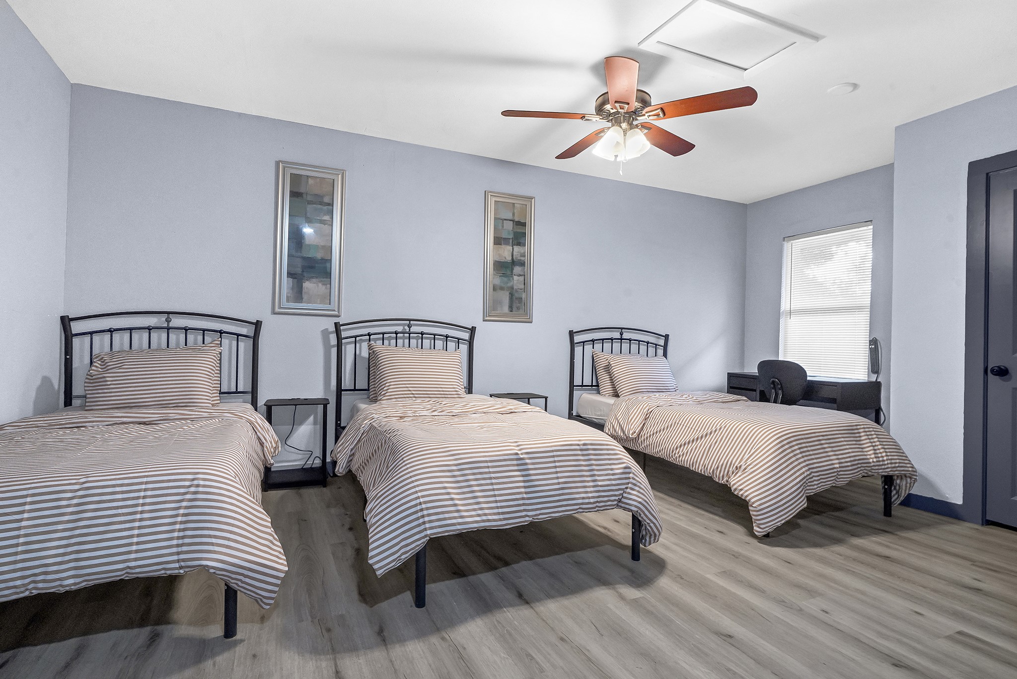 11103 Greenwillow Street Houston, TX 77035 - Photo 5 of 27 a bedroom with two beds and painting on the wall