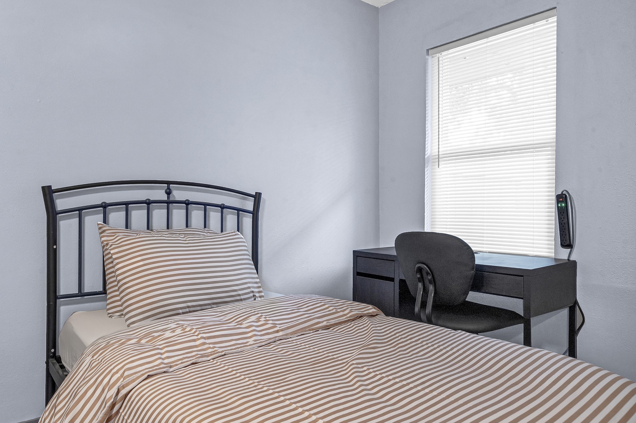 11103 Greenwillow Street Houston, TX 77035 - Photo 6 of 27 a bedroom with a bed a chair and a window