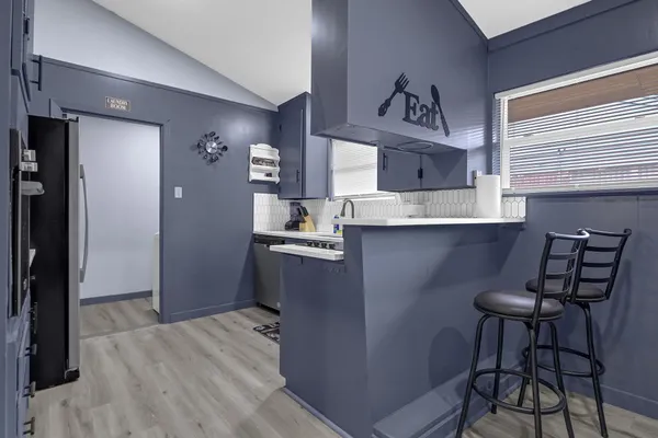 a kitchen with stainless steel appliances a sink stove and cabinets