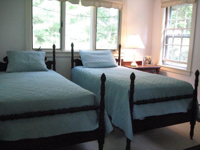 5 Squeteague Harbor Road Cataumet, MA 02534 - Photo 8 of 16 a bedroom with two beds and a large window