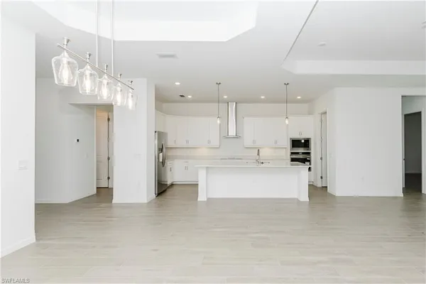 a kitchen with stainless steel appliances a sink a stove a microwave and refrigerator