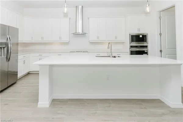 a bathroom with a sink a vanity and a large mirror