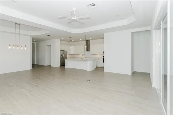 an empty room with a window and a ceiling fan