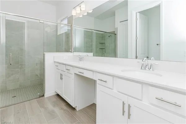 a bathroom with a sink vanity and a mirror