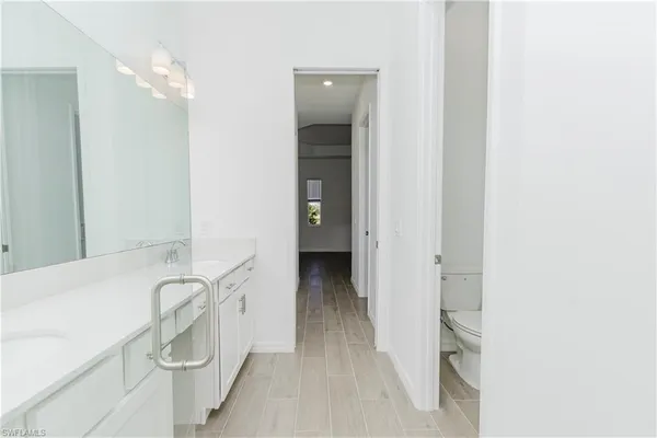 a bathroom with a sink mirror and a shower