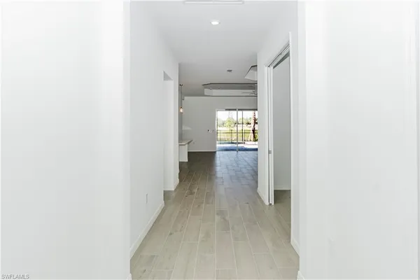 an empty room with window and fan