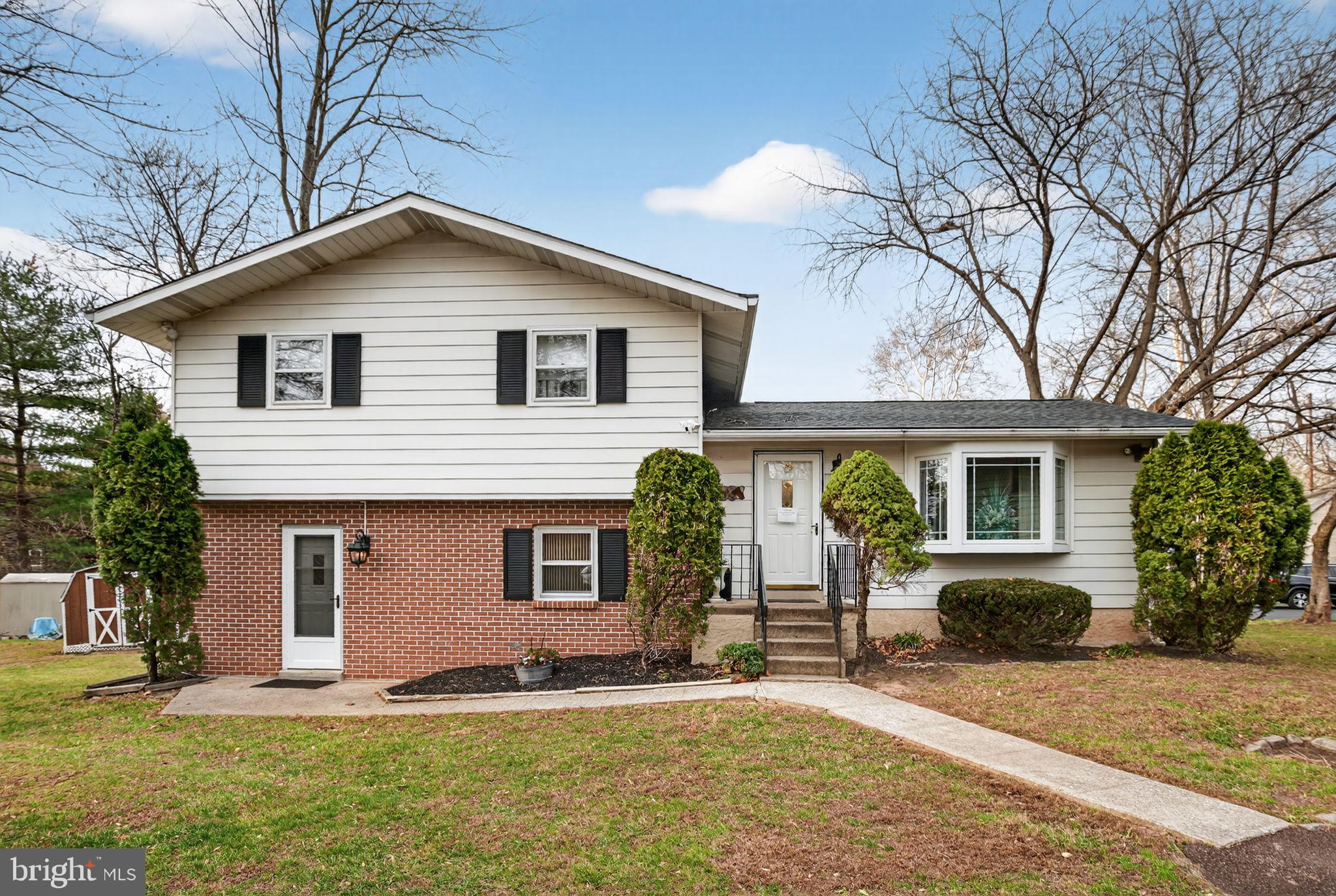 908 Pershing Road Blue Bell, PA 19422 - Photo 1 of 24 a front view of house with yard and trees in the background