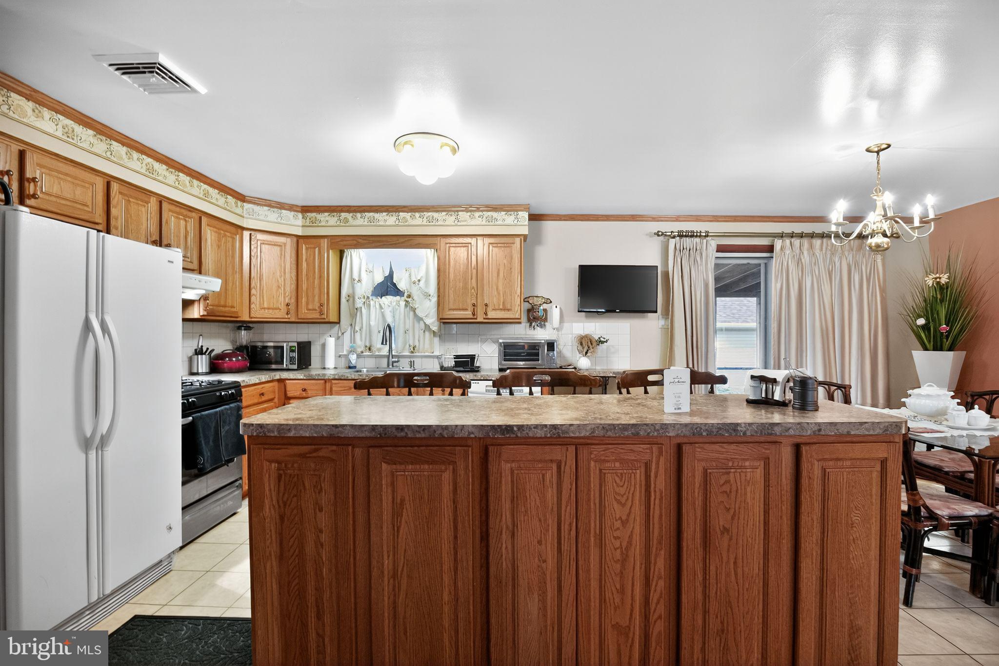 908 Pershing Road Blue Bell, PA 19422 - Photo 11 of 24 a kitchen with kitchen island granite countertop a sink stove and refrigerator