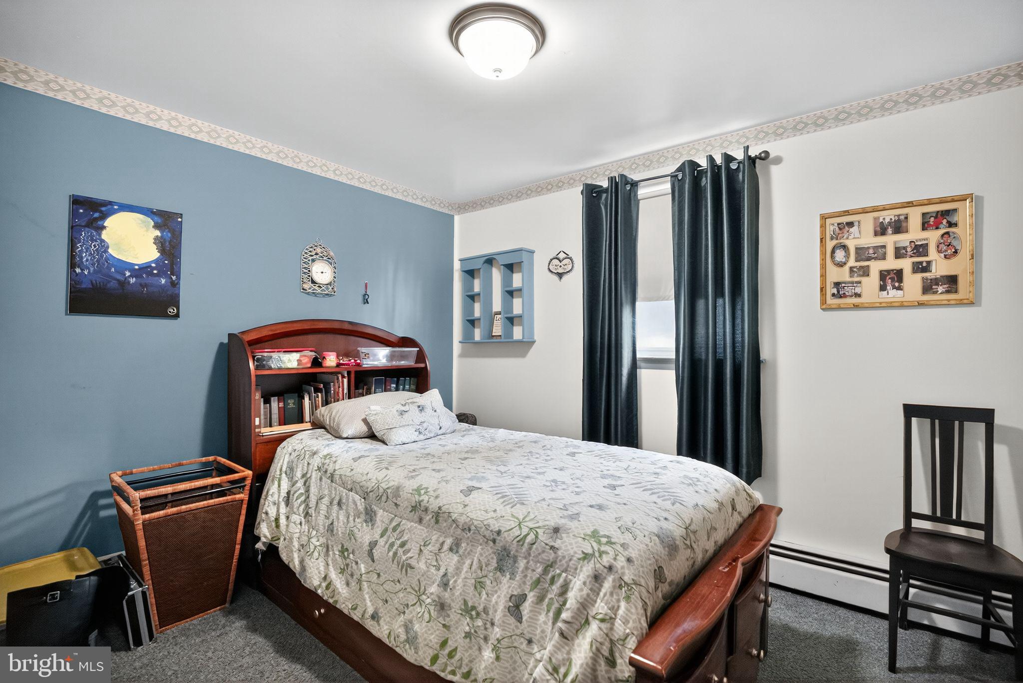 908 Pershing Road Blue Bell, PA 19422 - Photo 18 of 24 a bedroom with a bed and a lamp with window