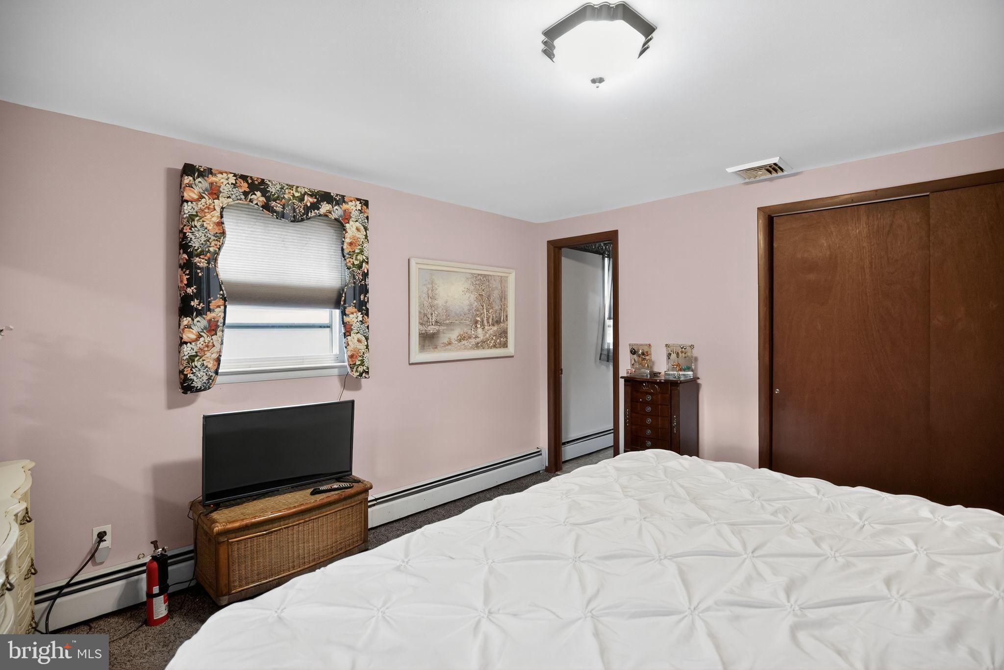 908 Pershing Road Blue Bell, PA 19422 - Photo 20 of 24 a bedroom with a bed and a flat tv screen