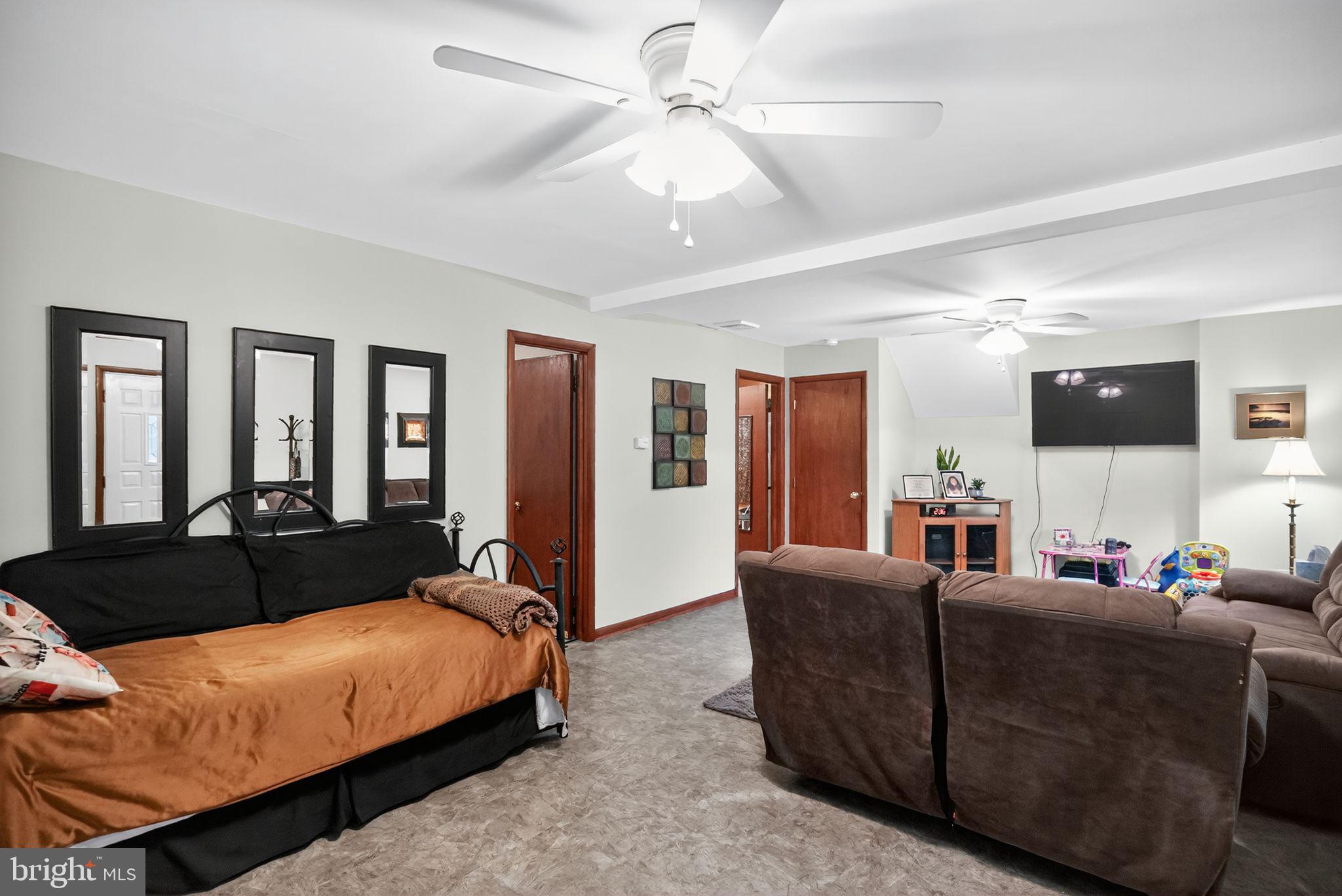 908 Pershing Road Blue Bell, PA 19422 - Photo 23 of 24 a living room with furniture ceiling fan and a flat screen tv