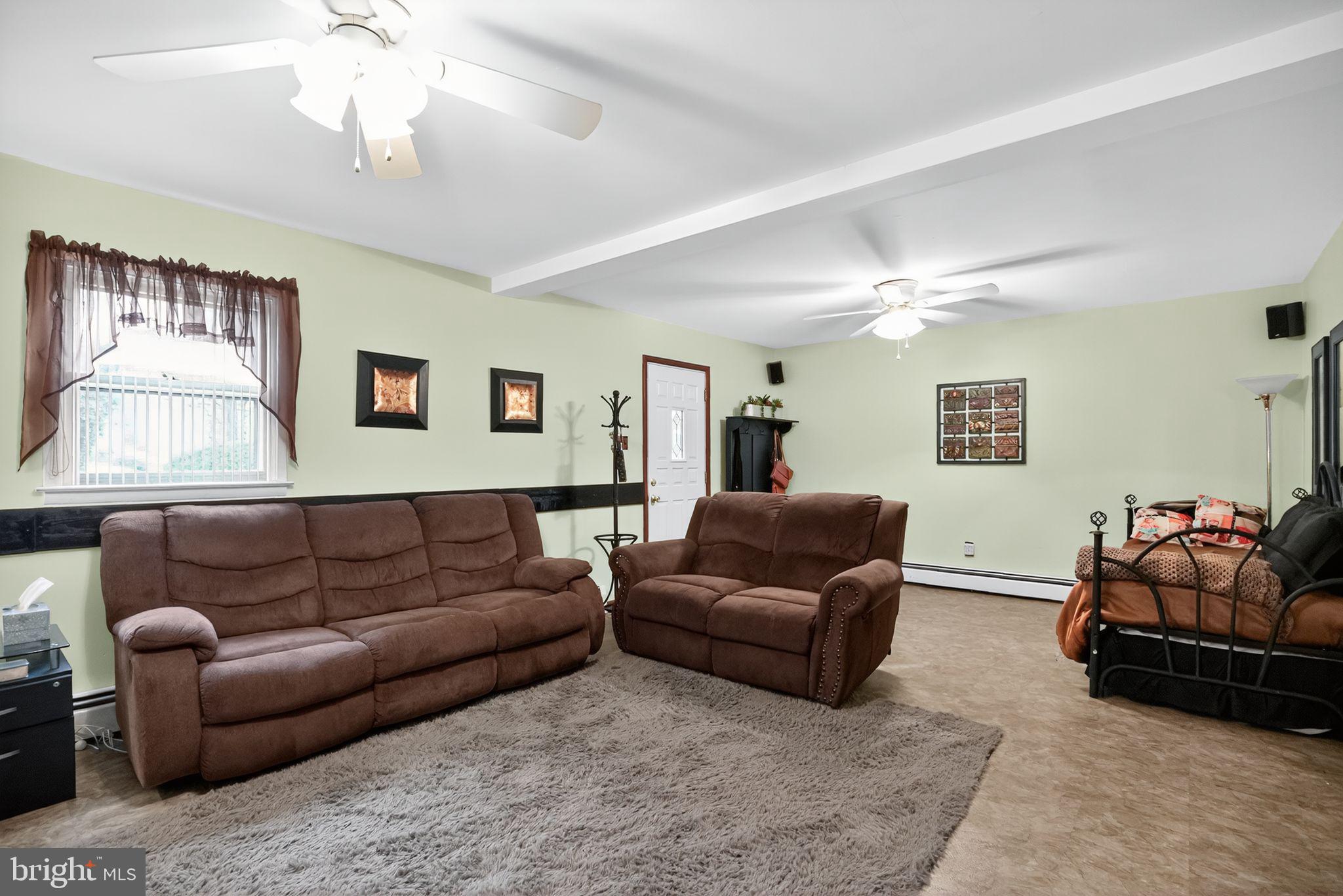 908 Pershing Road Blue Bell, PA 19422 - Photo 24 of 24 a living room with furniture ceiling fan and a window