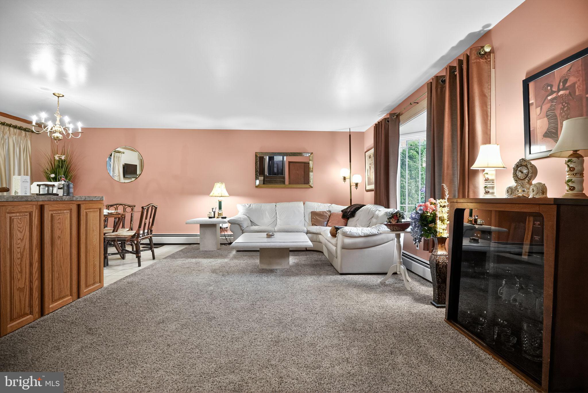 908 Pershing Road Blue Bell, PA 19422 - Photo 7 of 24 a living room with furniture and large windows