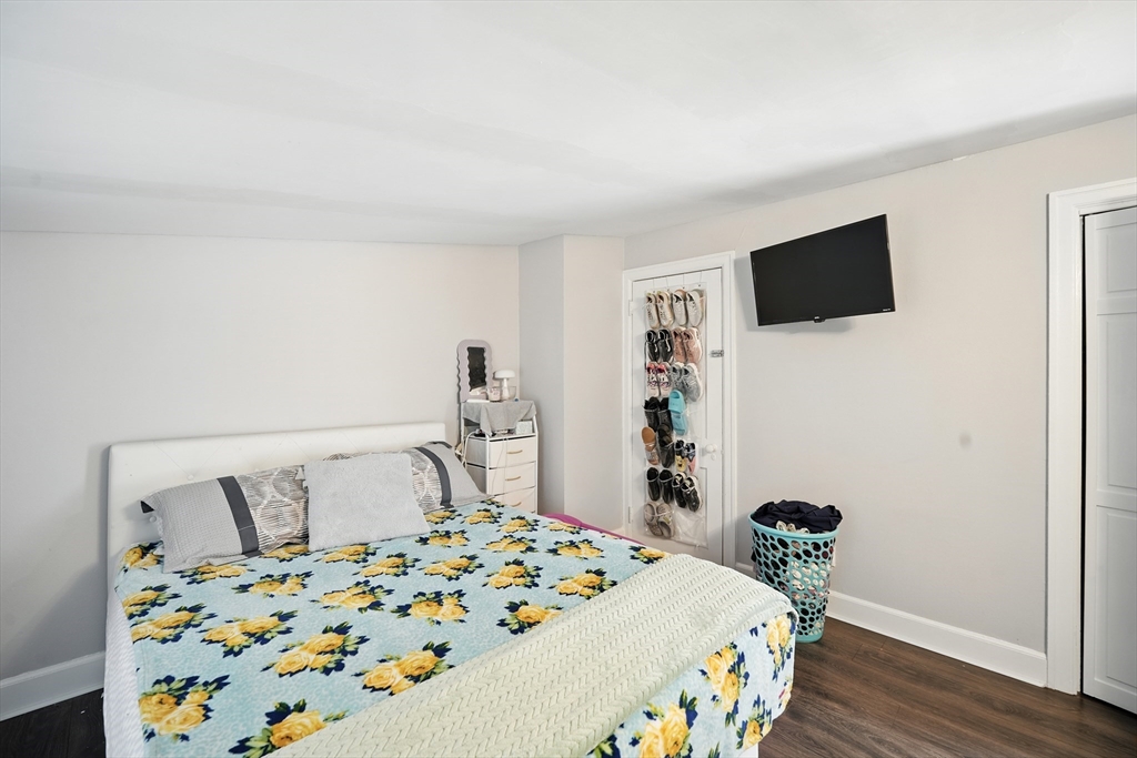 130 Eddy Street Springfield, MA 01104 - Photo 17 of 24 a bedroom with a bed and a flat screen tv