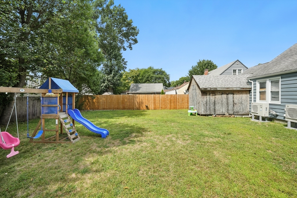 130 Eddy Street Springfield, MA 01104 - Photo 19 of 24 a view of a house with a backyard and a slide