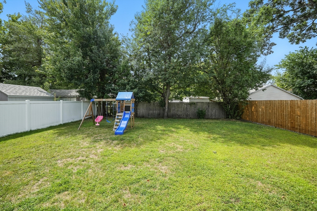 130 Eddy Street Springfield, MA 01104 - Photo 23 of 24 a backyard of a house with childrens swings and slides