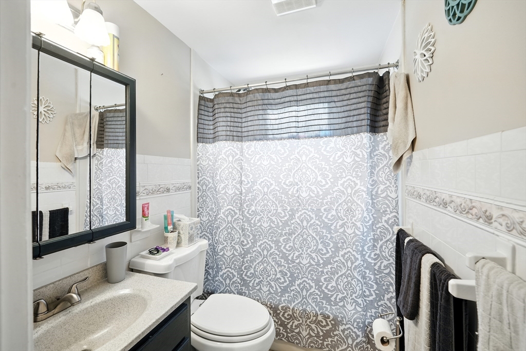 130 Eddy Street Springfield, MA 01104 - Photo 5 of 24 a bathroom with a toilet a sink and a mirror