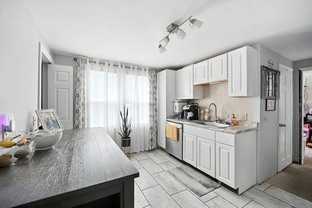 130 Eddy Street Springfield, MA 01104 - Photo 8 of 24 a kitchen with granite countertop a sink appliances cabinets and counter space