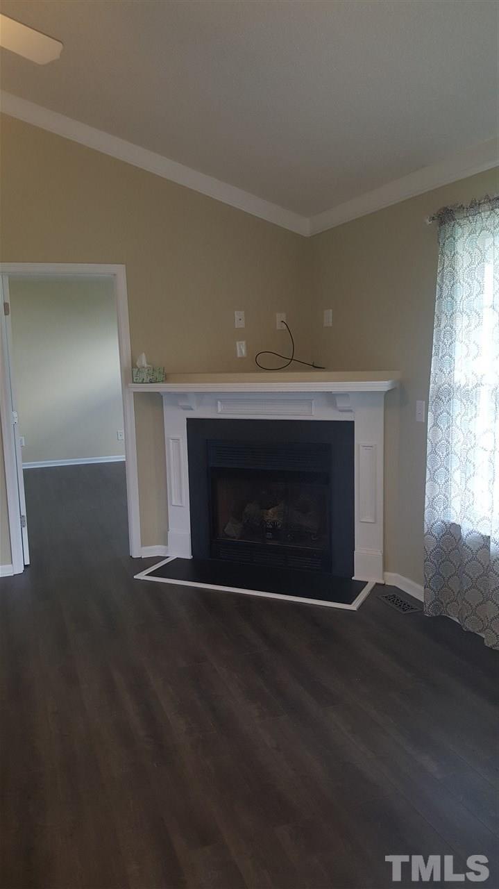 668 Slate Top House Road Clayton, NC 27520 - Photo 15 of 27 Living Room boasts Cathedral Ceilings as well as newly installed floors and Fireplace. This home has it all.