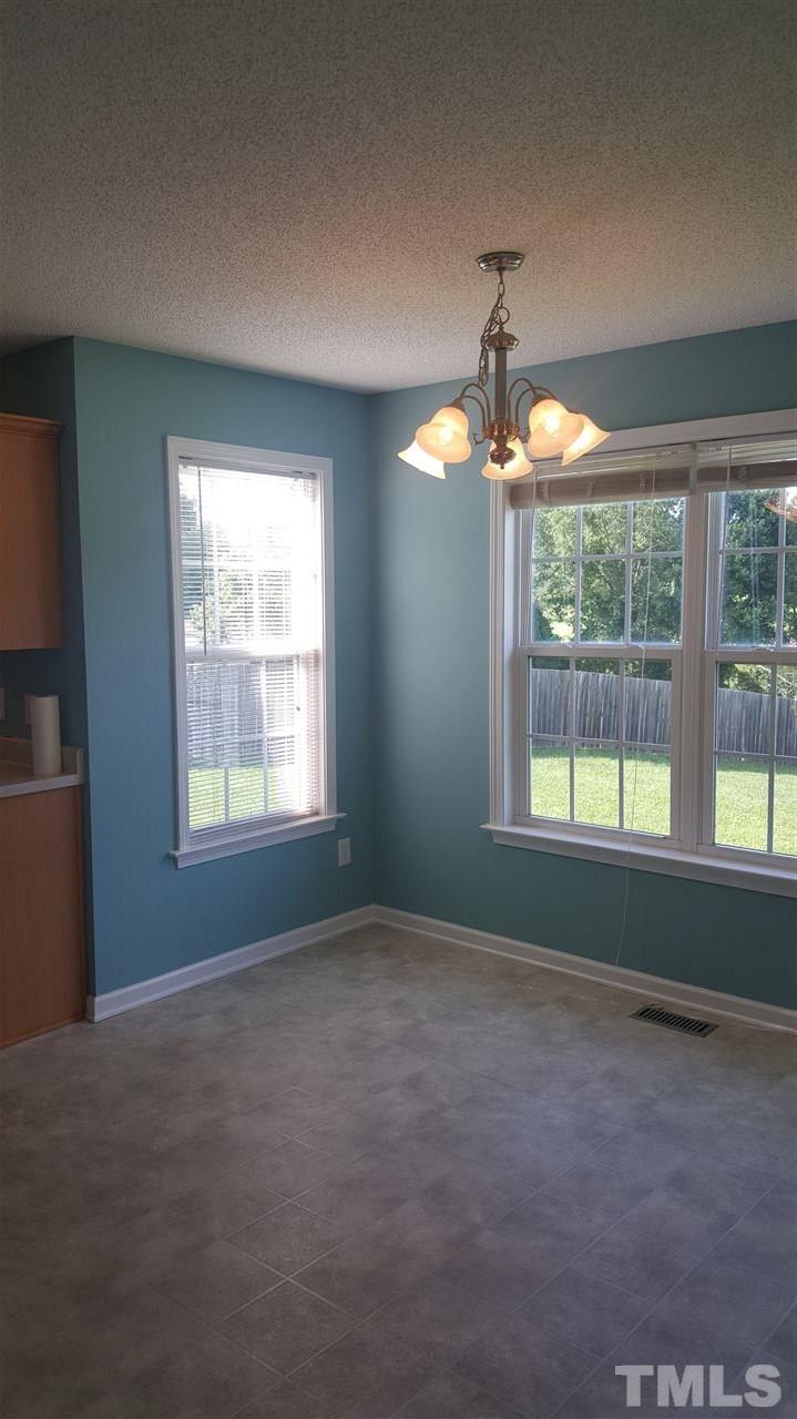 668 Slate Top House Road Clayton, NC 27520 - Photo 16 of 27 Dining Area is Large and accommodating! With easy access to the 10 x 15 Covered Back Deck-Porch area that overlooks a beautiful pond area behind the neighbors home.