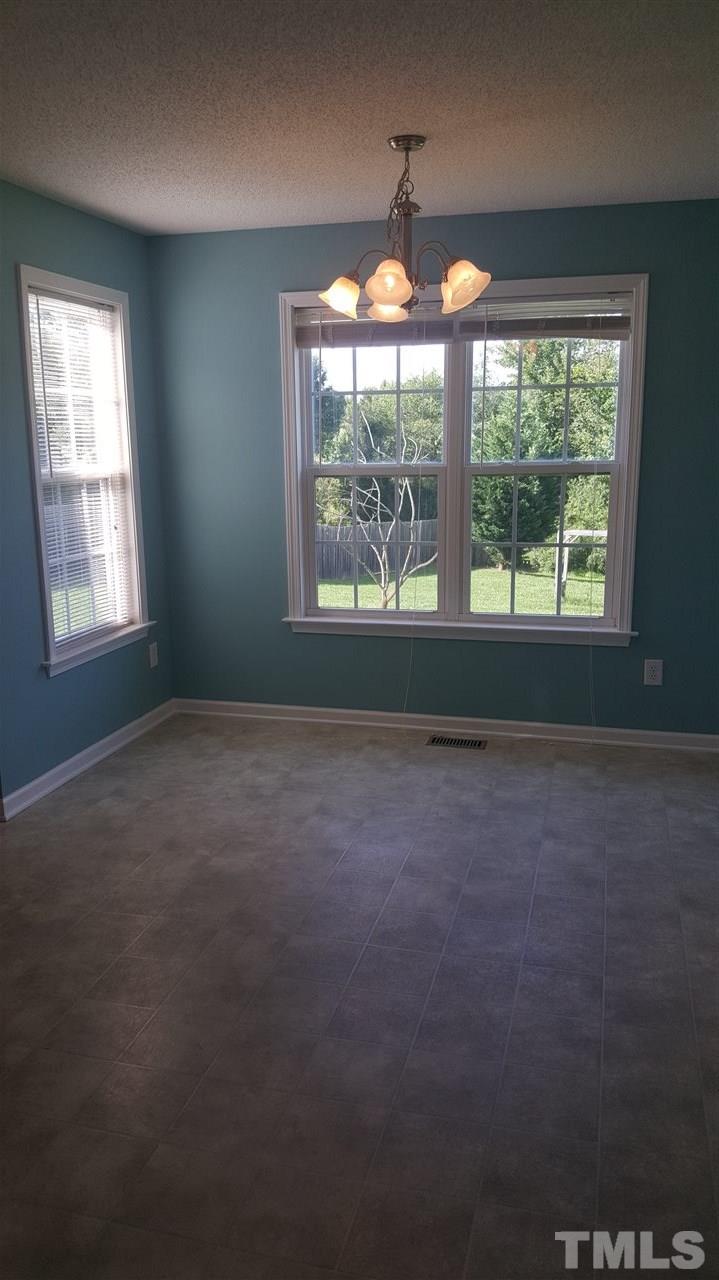 668 Slate Top House Road Clayton, NC 27520 - Photo 17 of 27 Another view of the large space for your dining table and entertaining your guests!