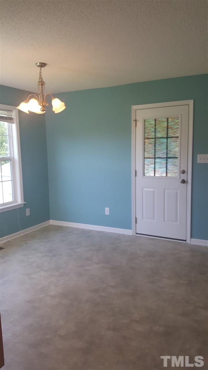 668 Slate Top House Road Clayton, NC 27520 - Photo 18 of 27 Right off the dining area you enter your covered Porch perfect for Grilling and chillin! 10 x 15 and Ready for Screen!