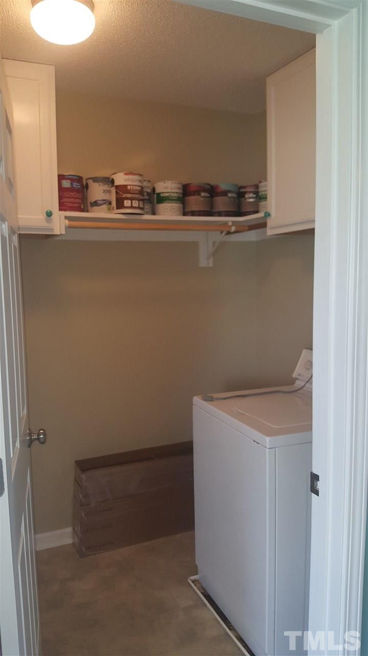 668 Slate Top House Road Clayton, NC 27520 - Photo 24 of 27 Plenty of room for your washer and dryer in this utility room. Storage too, with a door that can be closed off!