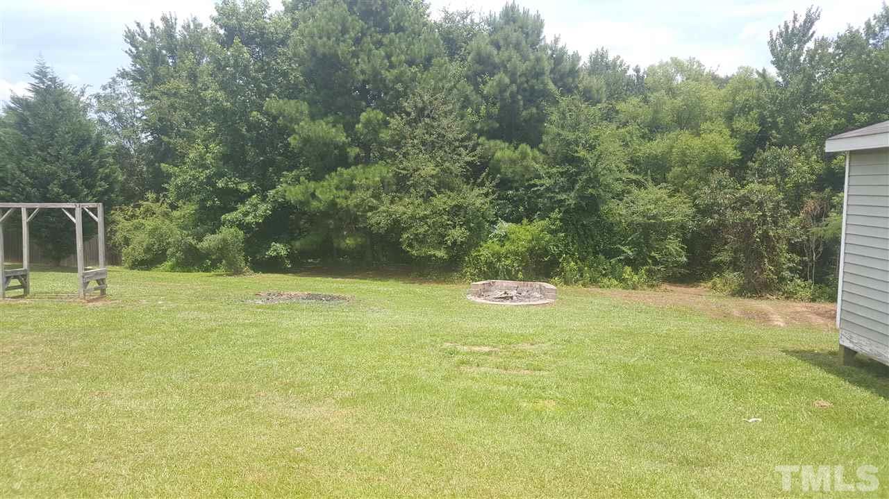 668 Slate Top House Road Clayton, NC 27520 - Photo 5 of 27 This Back Yard is Spacious, complete with Storage Building, Fire Pit, Previous Garden and Back Pathway to a Stream that flows into the Pond!