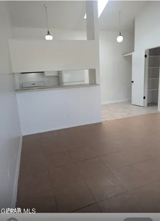 a kitchen with granite countertop white cabinets and white appliances