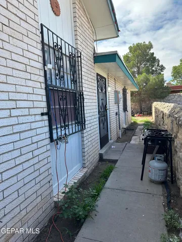 a view of a house with a yard and sitting area