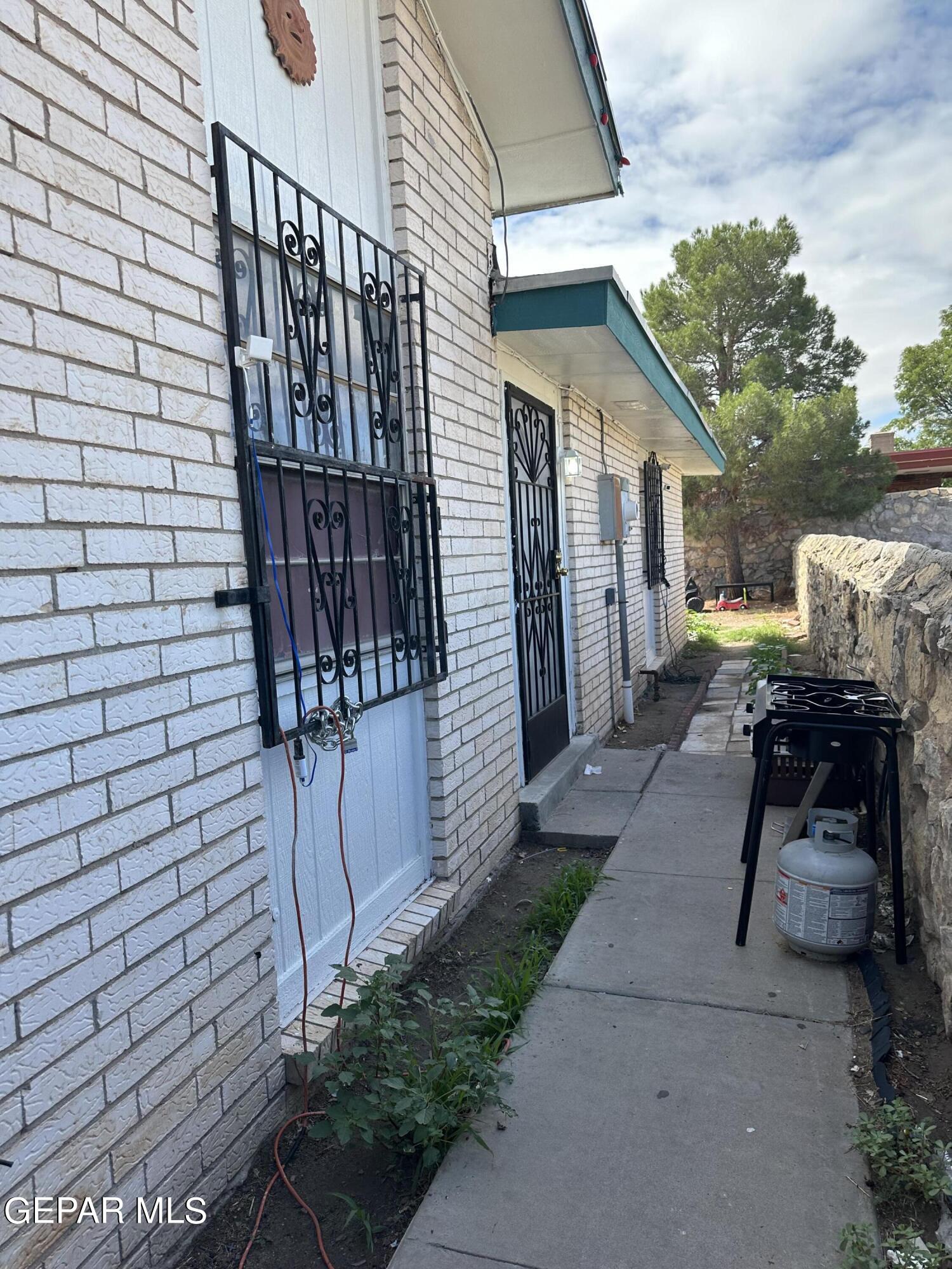 8138 St Andrew Lane, Unit ABCD El Paso, TX 79907 - Photo 9 of 18 a view of a patio with table and chairs with wooden fence and plants