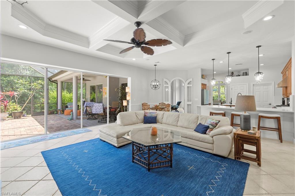 22043 Sycamore Grove Estero, FL 34135 - Photo 20 of 44 a living room with furniture wooden floor and a large window