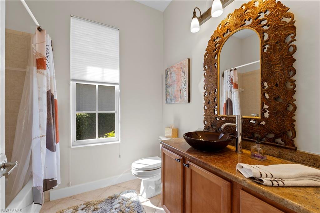 22043 Sycamore Grove Estero, FL 34135 - Photo 23 of 44 a bathroom with a sink and a mirror