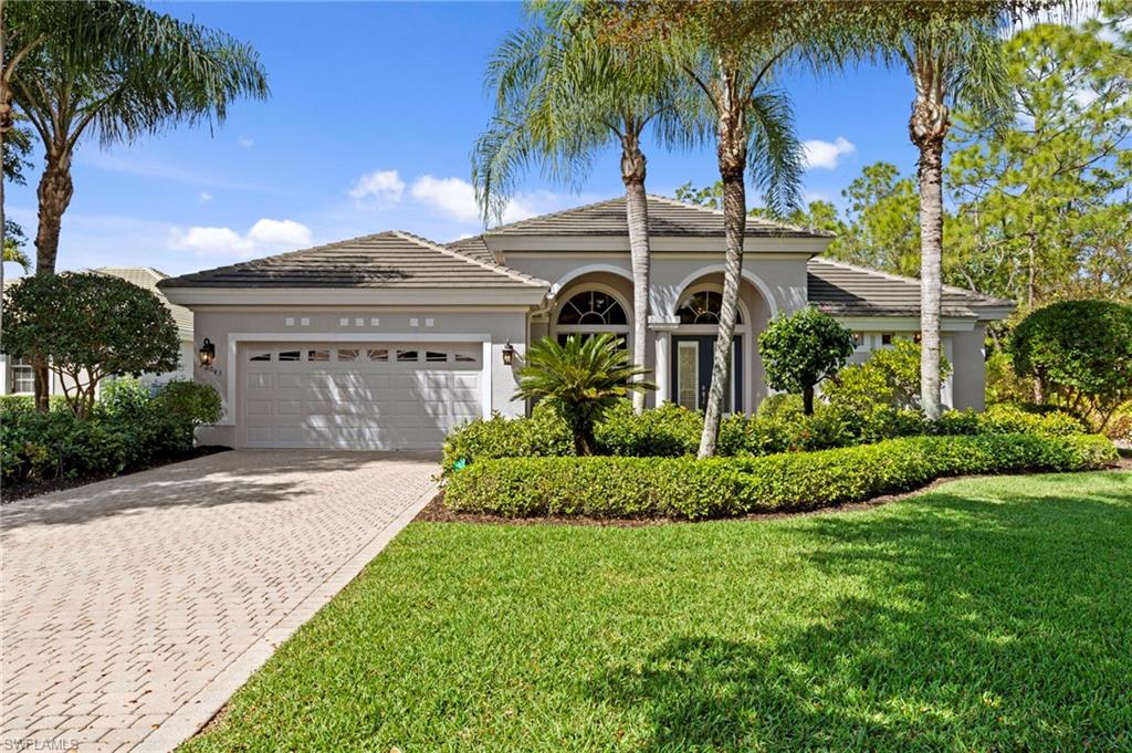 22043 Sycamore Grove Estero, FL 34135 - Photo 3 of 44 a front view of a house with a garden